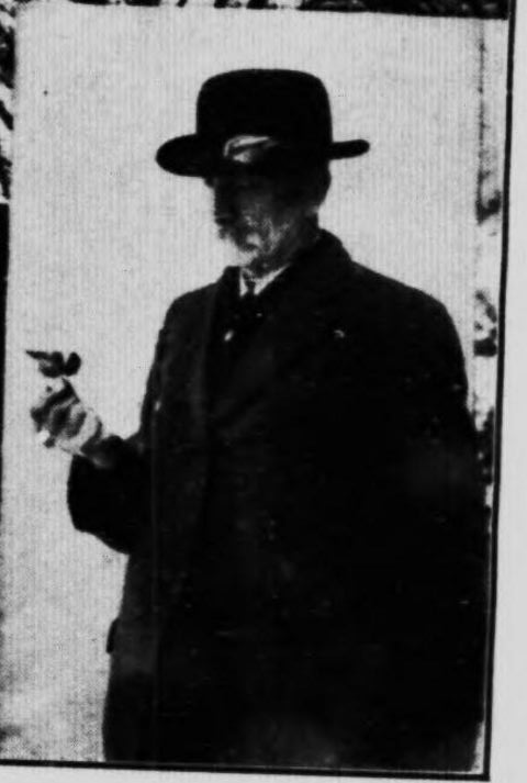 Grainy photo of Marrison and what appears to be a chickadee from his book.